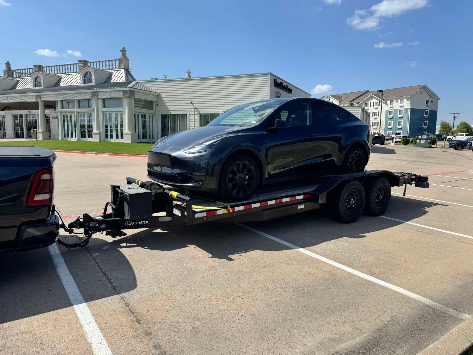 20 ft car hauler trailer loaded with a black Tesla Model Y
